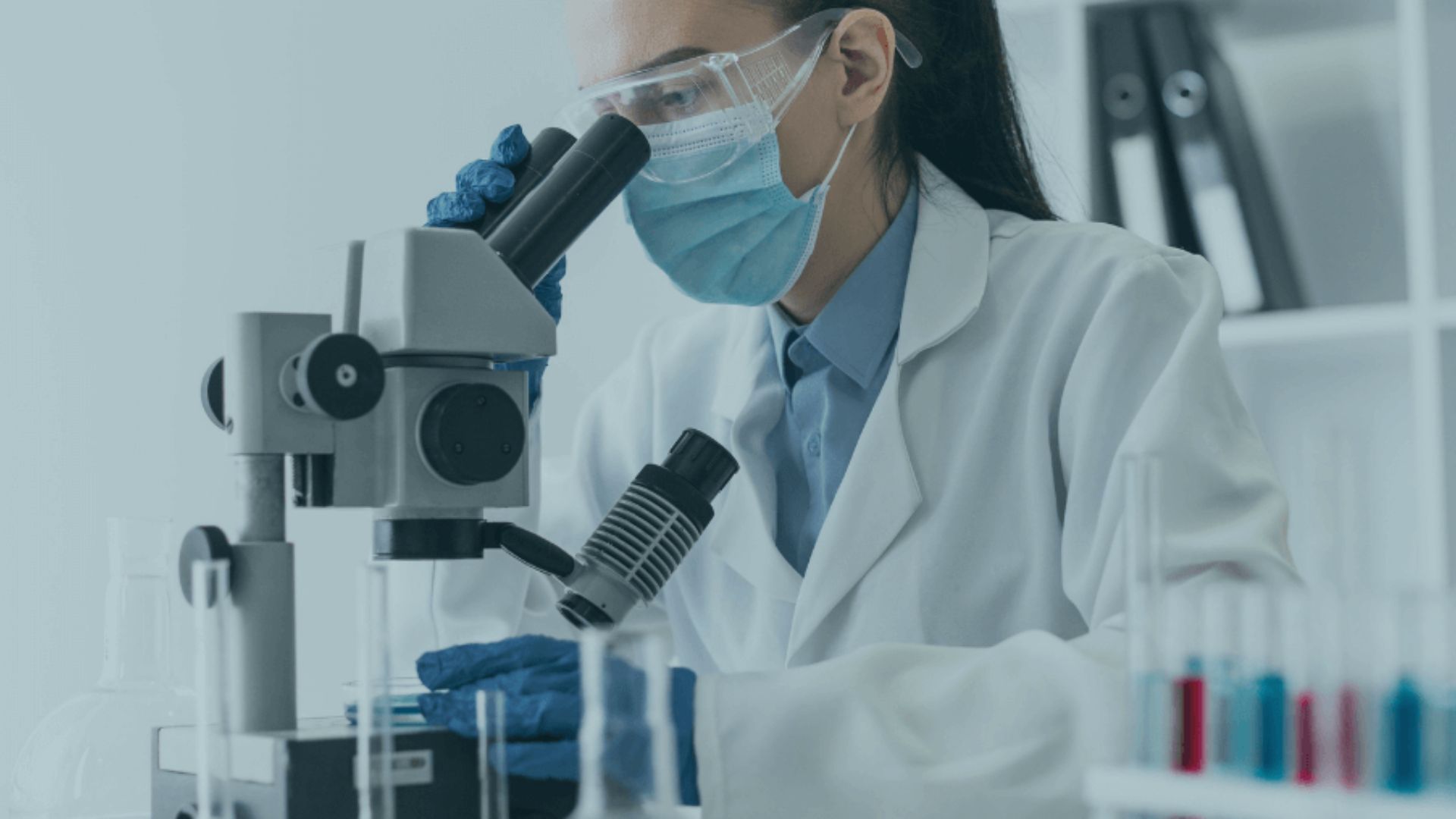 Foto de científica usando un microscopo